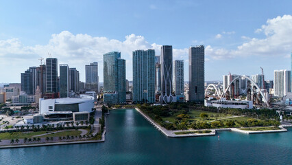 Aerial drone view of Miami skyline with waterfront park and urban canal