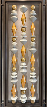 Series of 3d carved giant spindle or ballustrade similar to abacus shape, installed inside a wooden frame. Finished in metallic gold and silver paint. Seamless background texture.
