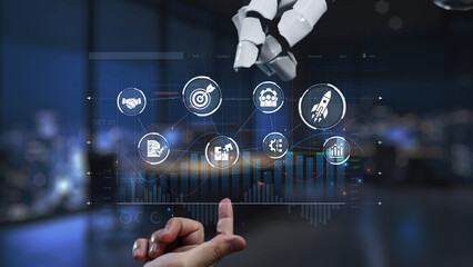 A robotic hand interacts with a digital interface showcasing data visualization elements for innovative automation in a modern workspace. Synapse