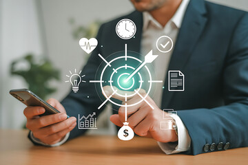 Businessman analyzing data with smartphone and digital interface