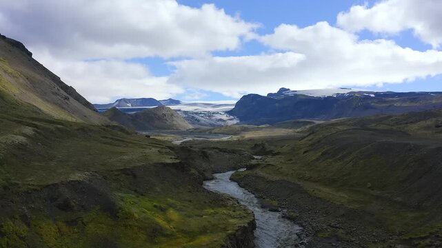 Panoramic Vista of Glacial River Valley and Snowy Moutains