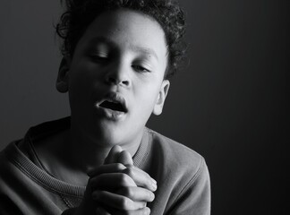 little boy praying to God with hands together with people stock image stock photo 