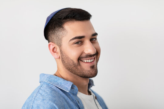 Confident Guy. Closeup headshot portrait of casual positive bearded jewish male in kipa standing at studio, looking and posing at camera isolated on white studio background