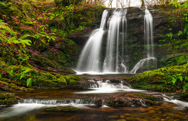 Fototapeta premium The Matxaingo ur-salto waterfall in Areso cascades down rocks and moss. The long exposure turns the water into white silk, capturing the natural peacefulness of Navarre.