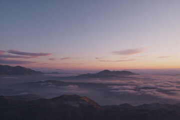 Mountain range at sunrise with clouds and fog mountains