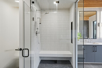 Bathroom with a white tile floor and a bench