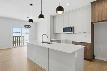 Kitchen with a white counter and a black microwave
