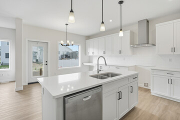 Kitchen with a white island and stainless steel appliances