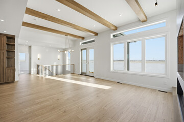 Fototapeta premium Large open living room with a fireplace and a view of the water