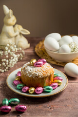  Easter spring holiday background. Cake with chocolate easter eggs, gypsophila flowers and cute bunnies