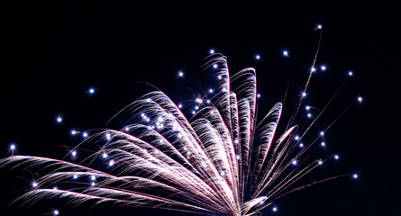 Vivid fireworks illuminate night sky, Celebratory fireworks light up festive evening