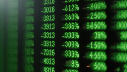 Close-up of a digital display showing fluctuating financial data in green font