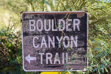 Rusty sign directing hikers to the Boulder Canyon Trail in Arizona Tonto National Forest