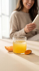 Woman Enjoying a Healthy Turmeric and Grapefruit Drink While Relaxing with a Book