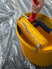  paint roller on a bucket with paint © Dusan Kostic