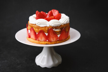 Strawberry shortcake on white cake stand dessert concept for party table decoration or celebration menu