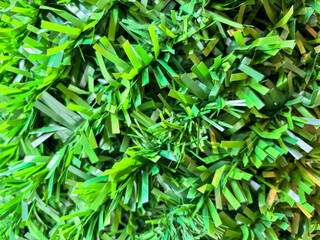 Macro shot of green plastic artificial grass texture