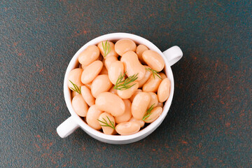 Plain white butter beans in bowl closeup for protein, diet or vegan food concept