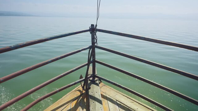 POV of wooden tour boat's bow on the Sea of Galilee in Israel Holy Land. Touristic vessel with rustic design referred to as Jesus boat styled after historical fishing boat from region sailing in lake