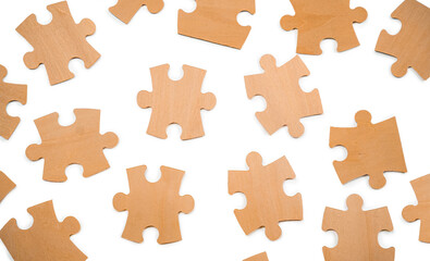 Various wooden puzzle pieces are spread out on a white background. People may come together to fit them together during a leisure time activity.
