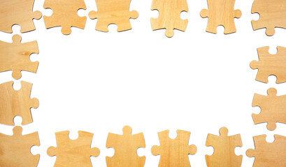 A circle of wooden puzzle pieces is placed on a white surface. These pieces are ready for someone to start assembling them into a complete puzzle for fun or challenge.