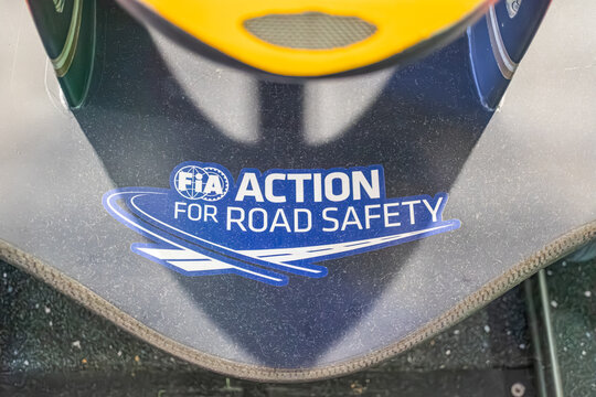 Summary Yellow Formula One car on display in a road safety museum or exhibition, backdrop with Road Safety text and FIA logo, sleek design emphasized by lighting, - Kyiv, Ukraine - June 8, 2025