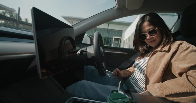 Smart woman drive EV car with navigator dashboard Transport technology