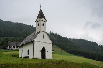 A beautiful white church on a mountainside in the Alps, Austria