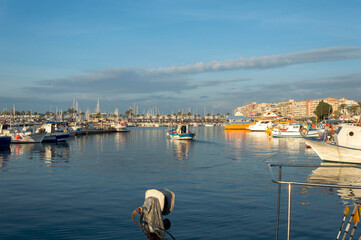 Small fishing boat leaving the port of Santa Pola early in the morning, Santa Pola, Alicante, Spain