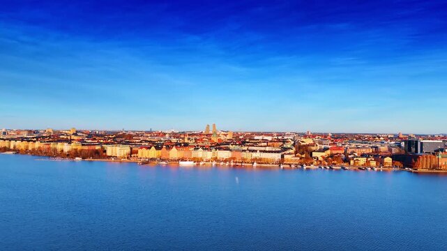 Sunny scenery of beautiful Stockholm, Sweden. Drone footage rising over the waterscape of Lake Malar.