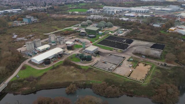 Aerial drone view of sewage plant industrial buildings, domed tanks and infrastructure for clean drinking water and sanitation in Derby, United Kingdom. 