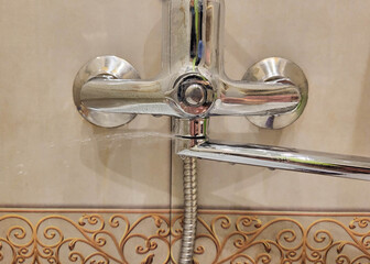 Water is flowing from the broken faucet. Water leakage and conservation.