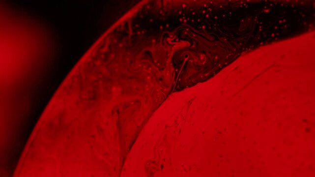 Red psychedelic fluid abstraction, glowing liquid background, bubbles in macro, connection of bubbles in macro, iridescent effect