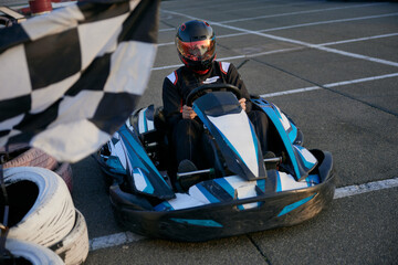 A thrilling moment captured as a go-kart racer speeds around the track