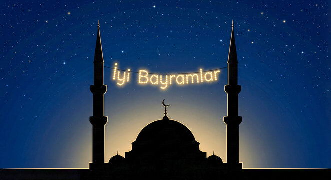 Iyi Bayramlar greeting hanging over a mosque silhouette at night