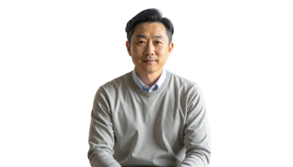 Portrait Of Mature Asian Man In Gray Sweater And Blue Shirt Looking At Camera With Neutral Expression For Business Or Personal
