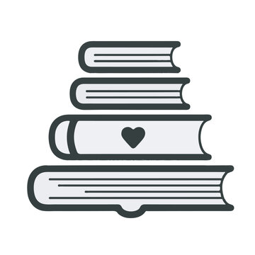 A stack of books with a heart on one book sits on a table indoors