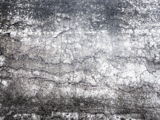 Grunge abstract background with cracked concrete surface, dark stains, scratches, and aged distressed texture, suitable for industrial, urban, or dramatic design use.