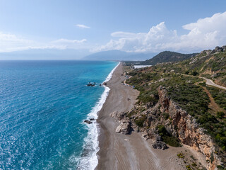 Aerial view of Mavikent Beach, with its long stretches of pebbled shoreline, clear blue water, and surrounding open landscapes in Antalya, Turkey.