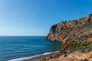 Fototapeta premium A beautiful blue ocean with a rocky cliff in the background
