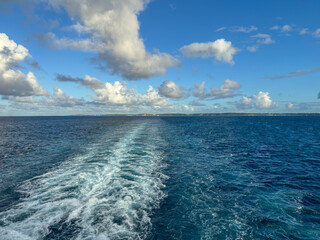 The churning blue water of a cruise ship wake on the Atlantic Ocean.
