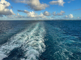 The churning blue water of a cruise ship wake on the Atlantic Ocean.