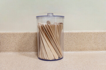 A container with tongue depressors at a medical office