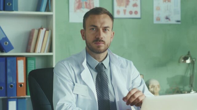 Doctor reviewing records, Dedicated doctor reviewing electronic records during remote consultation carefully
