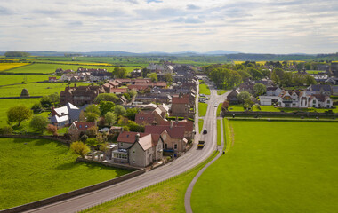 Fototapeta premium Scenic countryside village with winding road – Bamburgh Castle - England