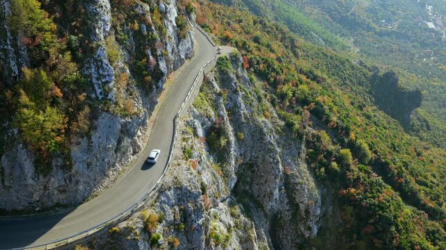Aerial video of a car driving on the winding mountain road connecting Sari Salltik viewpoint with the city centre of Kruj&euml;, Albania.