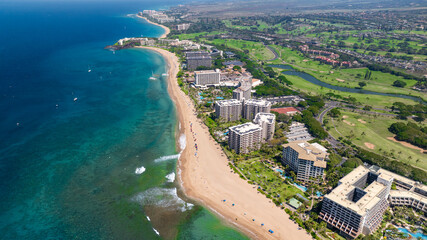 Panoramic Aerial view of beachfront resorts in Kaanapali, Maui, Hawaii cityscape showing condos and golf course landscape  