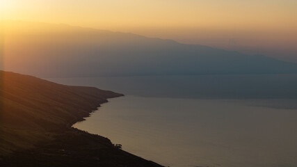 Aerial view of Maui, Hawaii beautiful landscape with ocean and mountains at golden hour sunset 