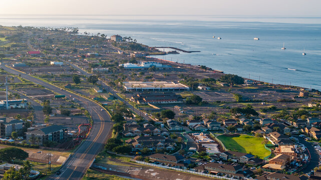 Aerial view of Lahaina landscape in Maui, Hawaii wildfire aftermath showing coastline, roads, homes, and ocean during morning light