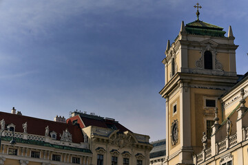 Historic baroque tower and architectural details against a clear
